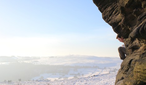 Guy escapes the crowd below and surveys a white peak from his perch on Mother Cap © Oli Grounsell